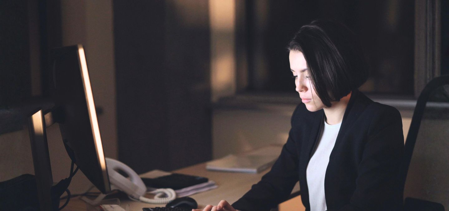 Woman sitting in front of her computer at work.