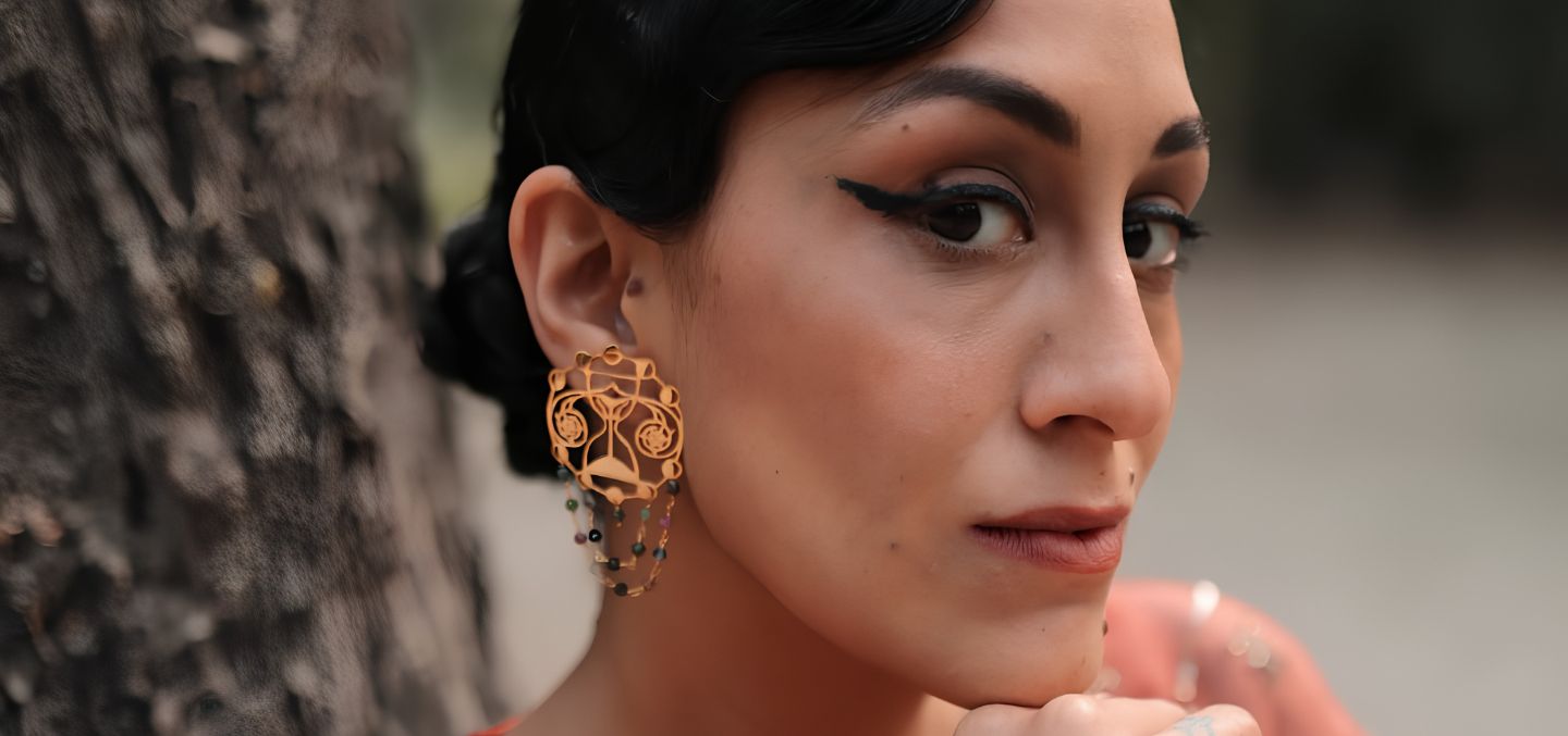 Poet and author Karuna Ezara Parikh wearing Eina Ahluwalia's Beyond Biological clock earrings.